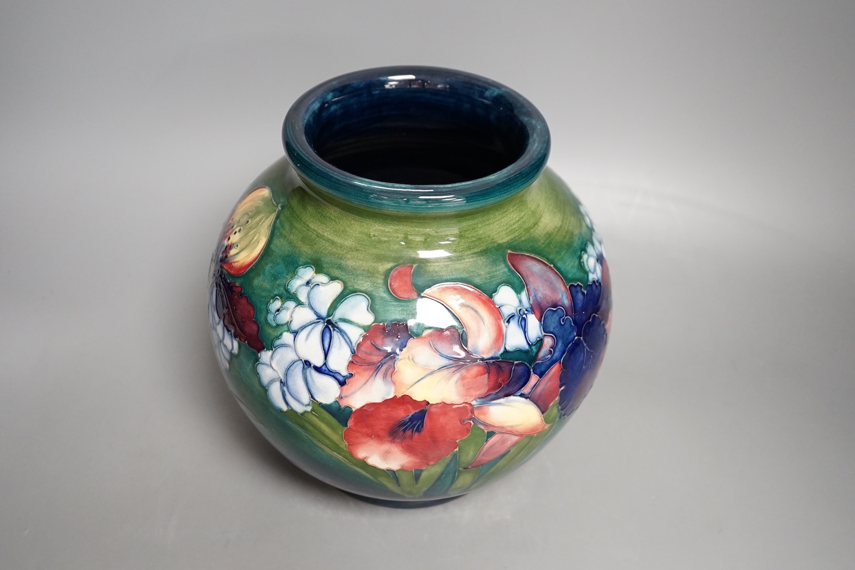 A Moorcroft green glaze 'spring flowers' squat vase, 21 cms high.